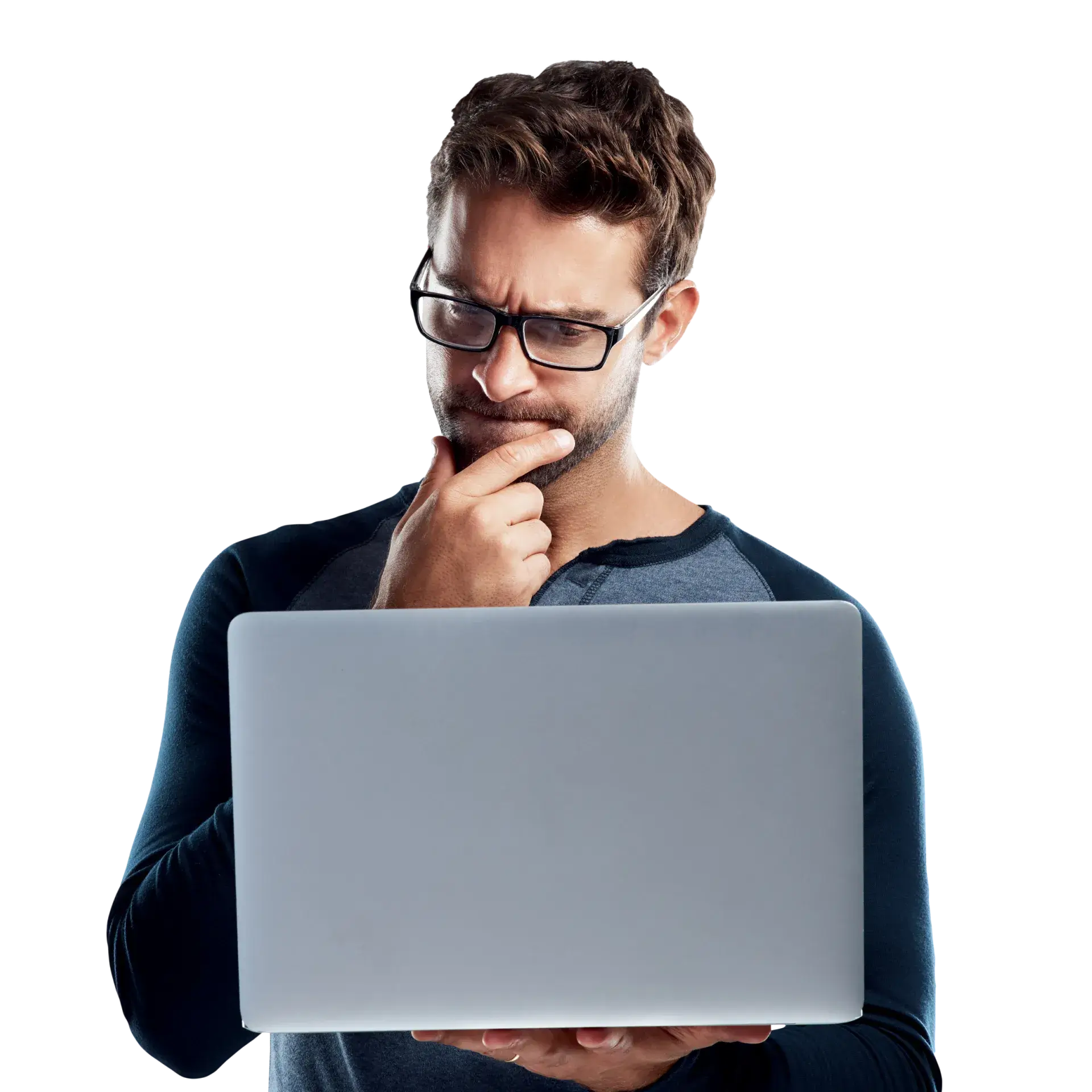 A man in glasses looking at a laptop.