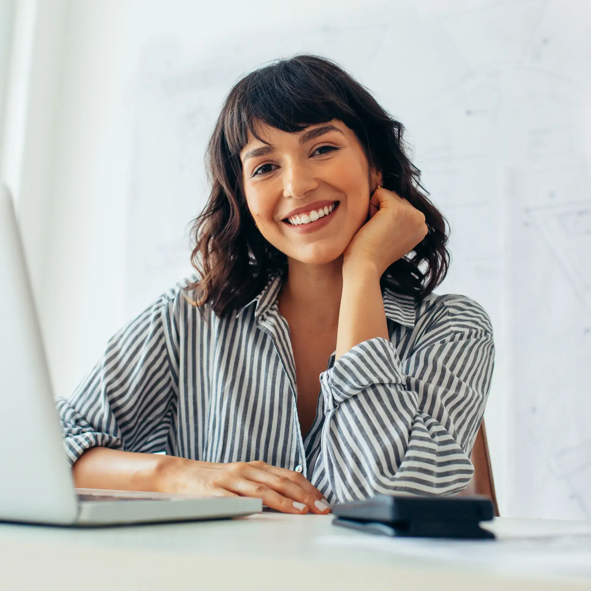 A woman sitting in front of a laptop computer.