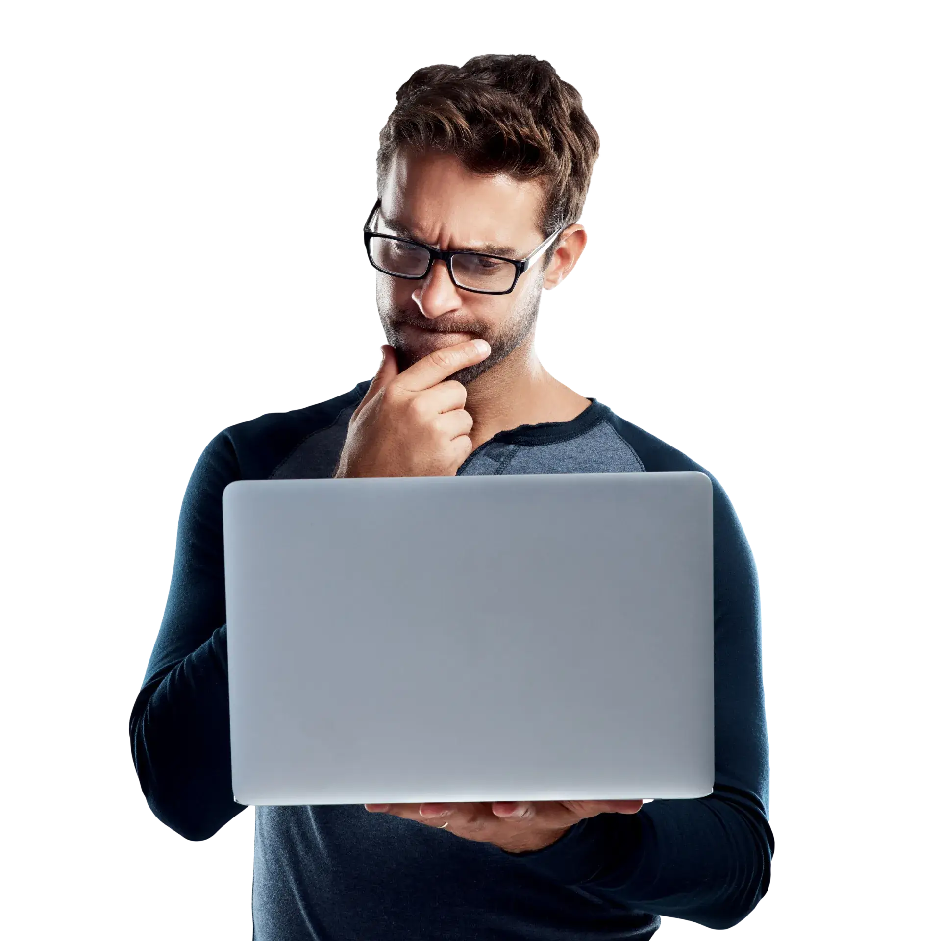 A man in glasses is looking at a laptop.