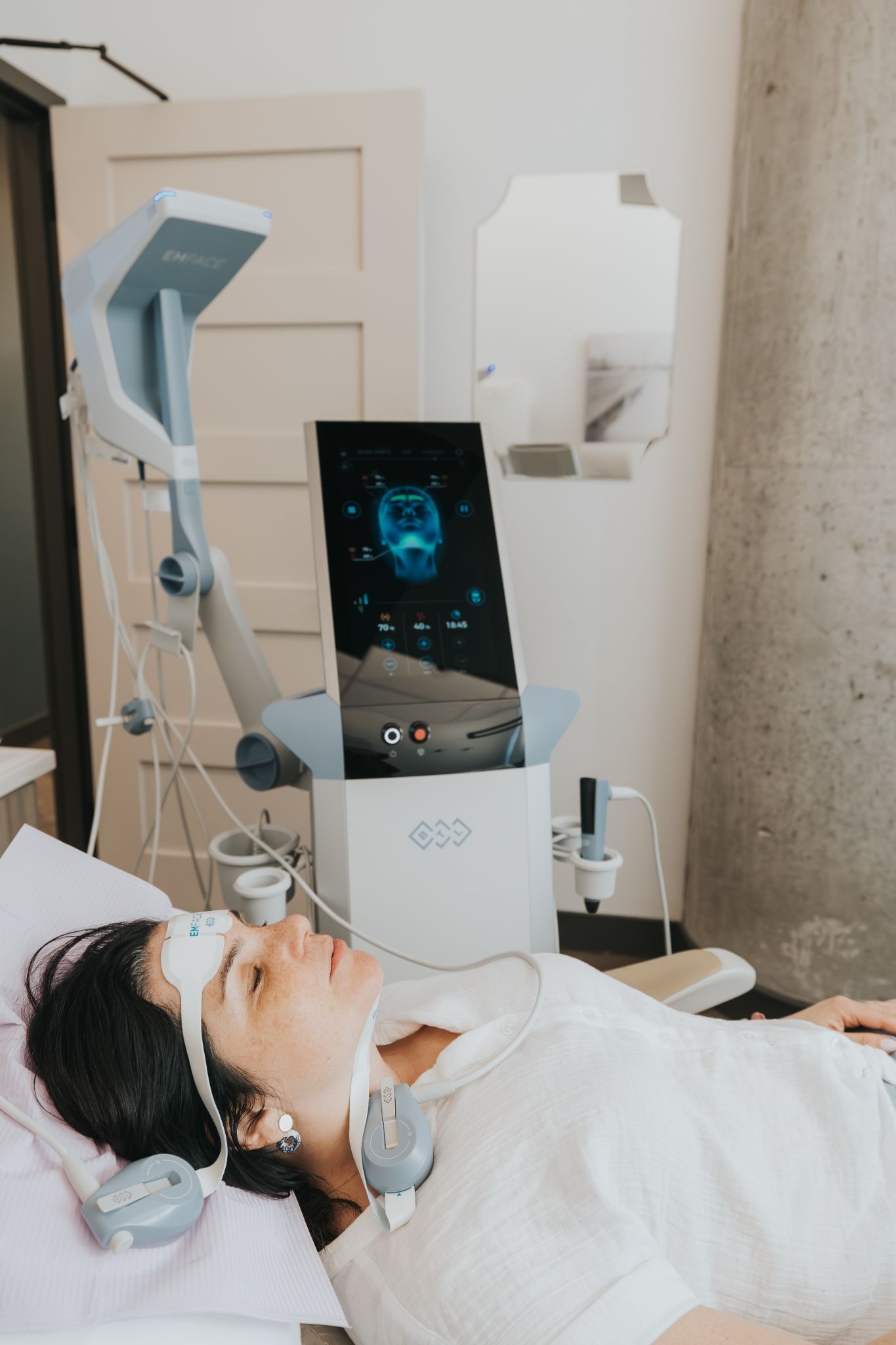 female patient laying down and getting emface treatment at printers row dental studio