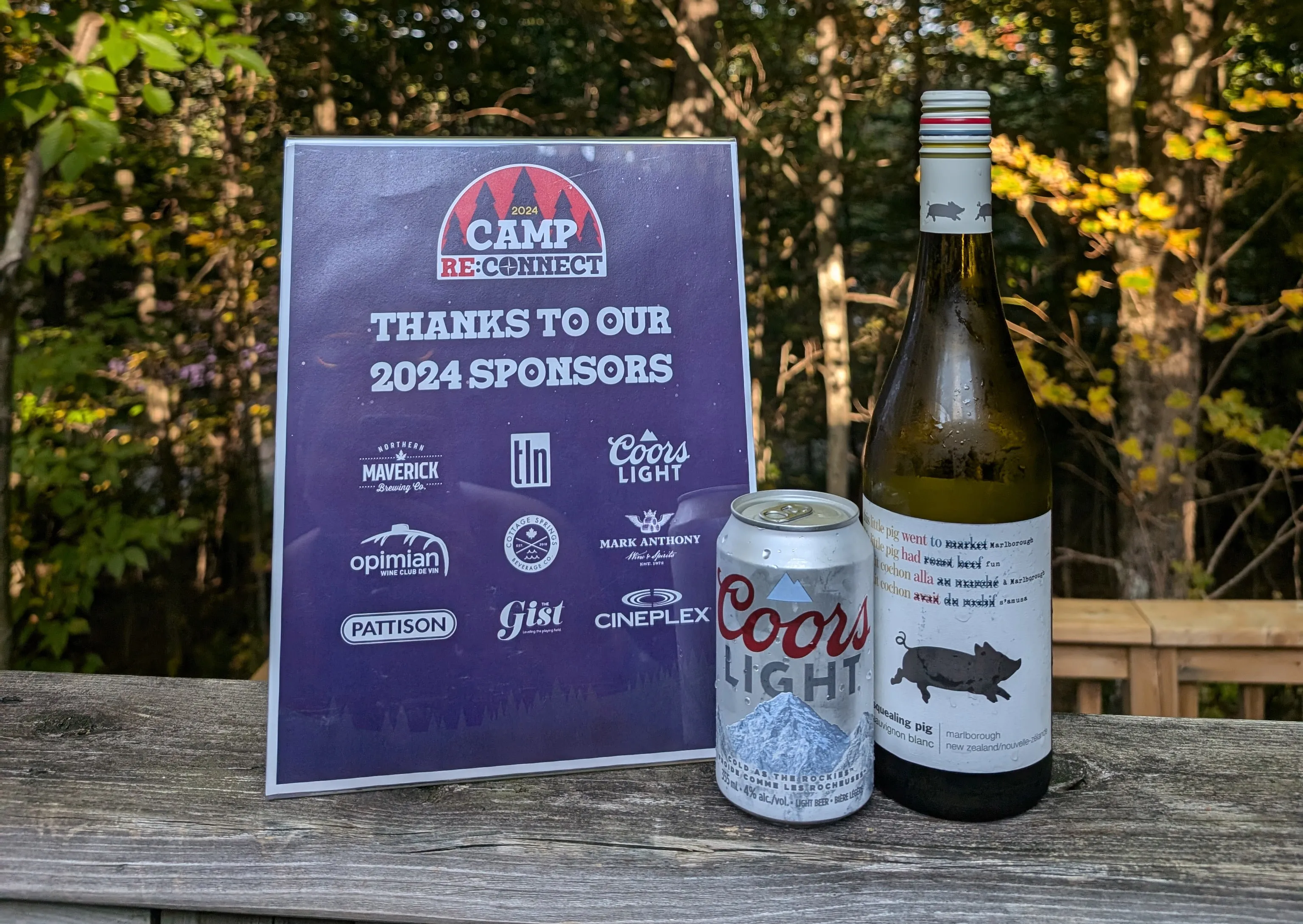 Camp signage next to drinks from sponsors.