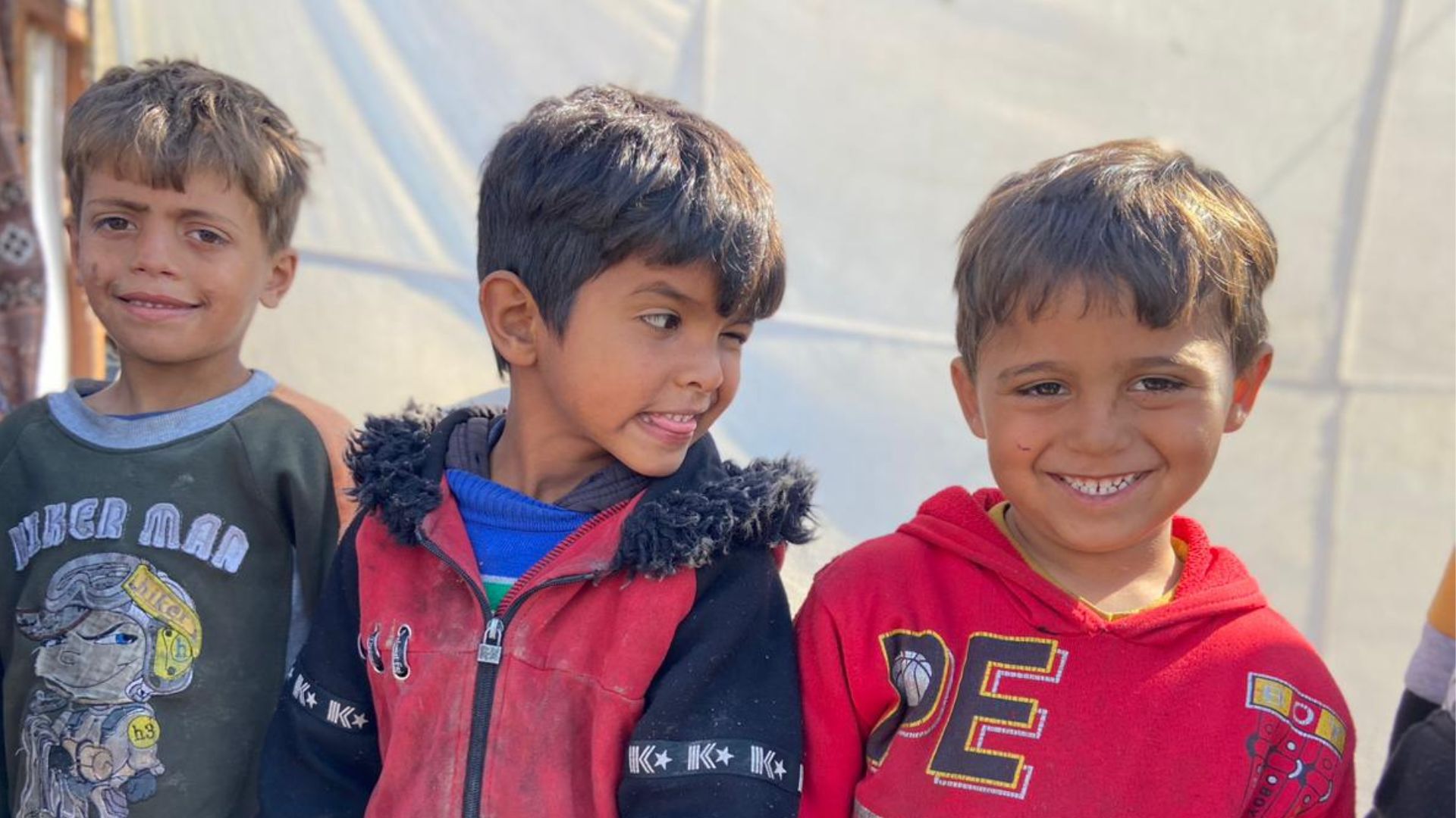 Orphaned children in Gaza smiling 
