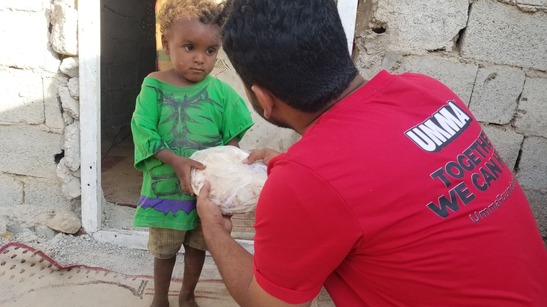 Umma Foundation food aid delivered to a child.