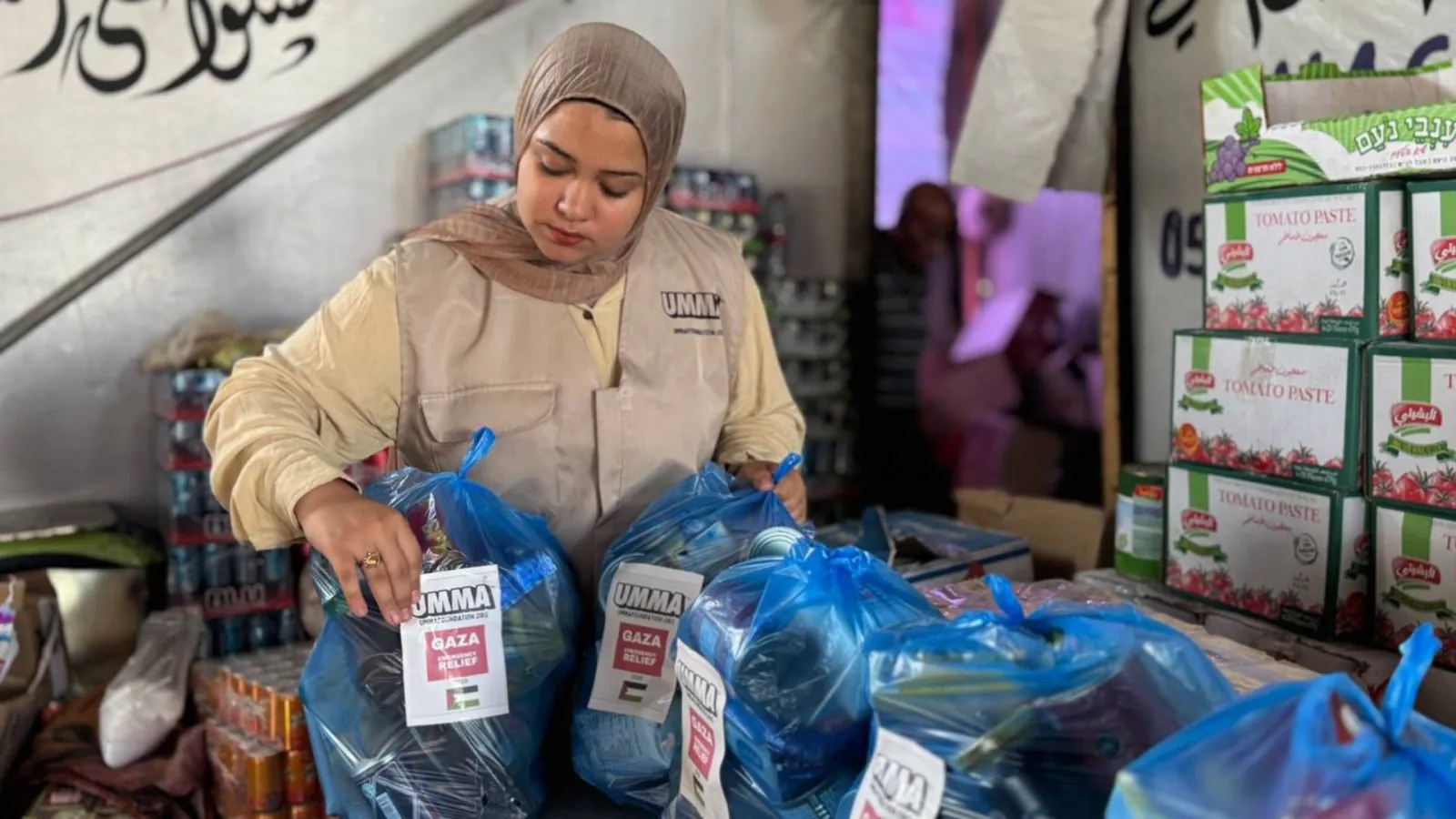 Umma volunteer packing Gaza faith-based relief aid.