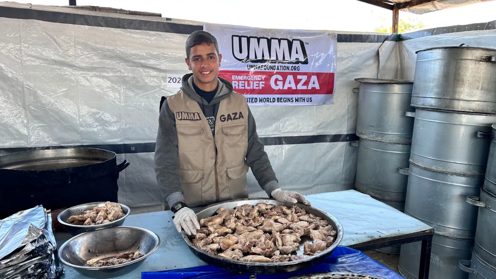UMMA volunteer serves hot meals in Gaza food relief.