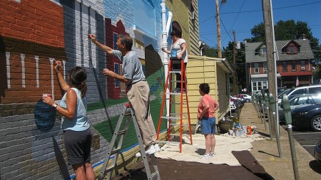 People painting the mural
