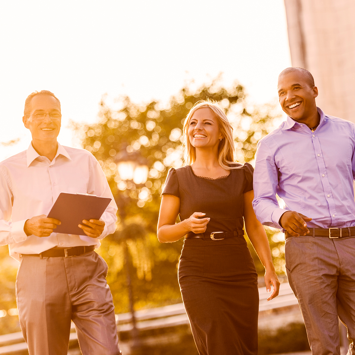 Group of attorneys walking in warm sunset light
