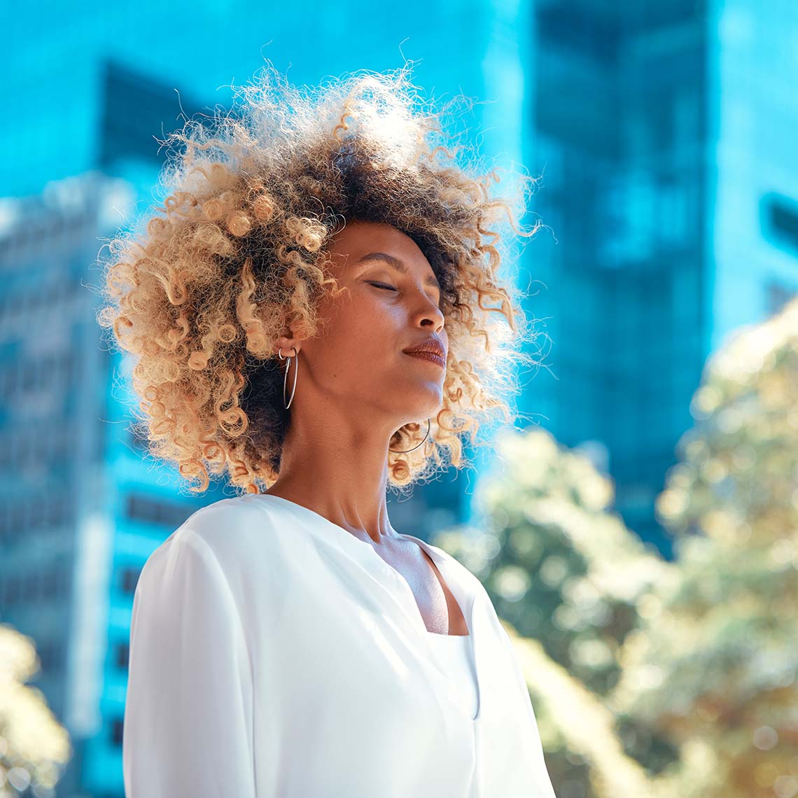Female attorney practicing breath work in the city