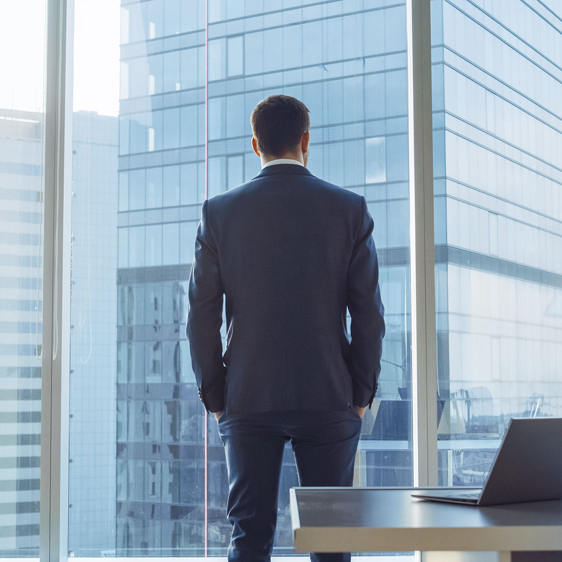 Male attorney in corner office looking out the window