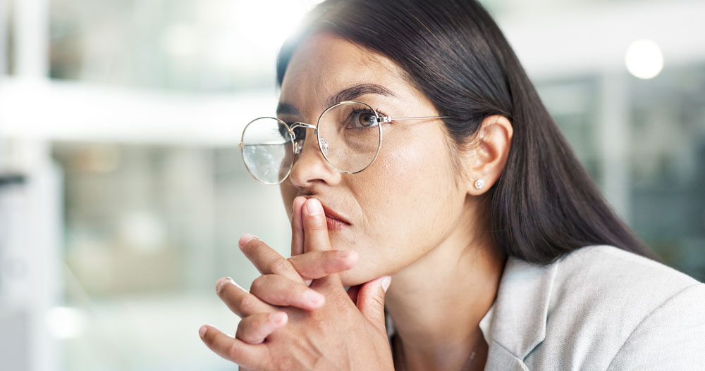 A female attorney wearing glasses and concentrating