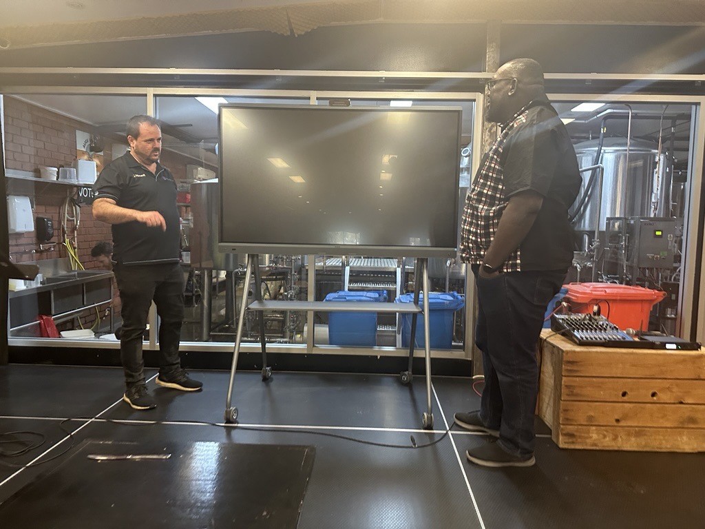 Technician speaking to a person about tech solutions