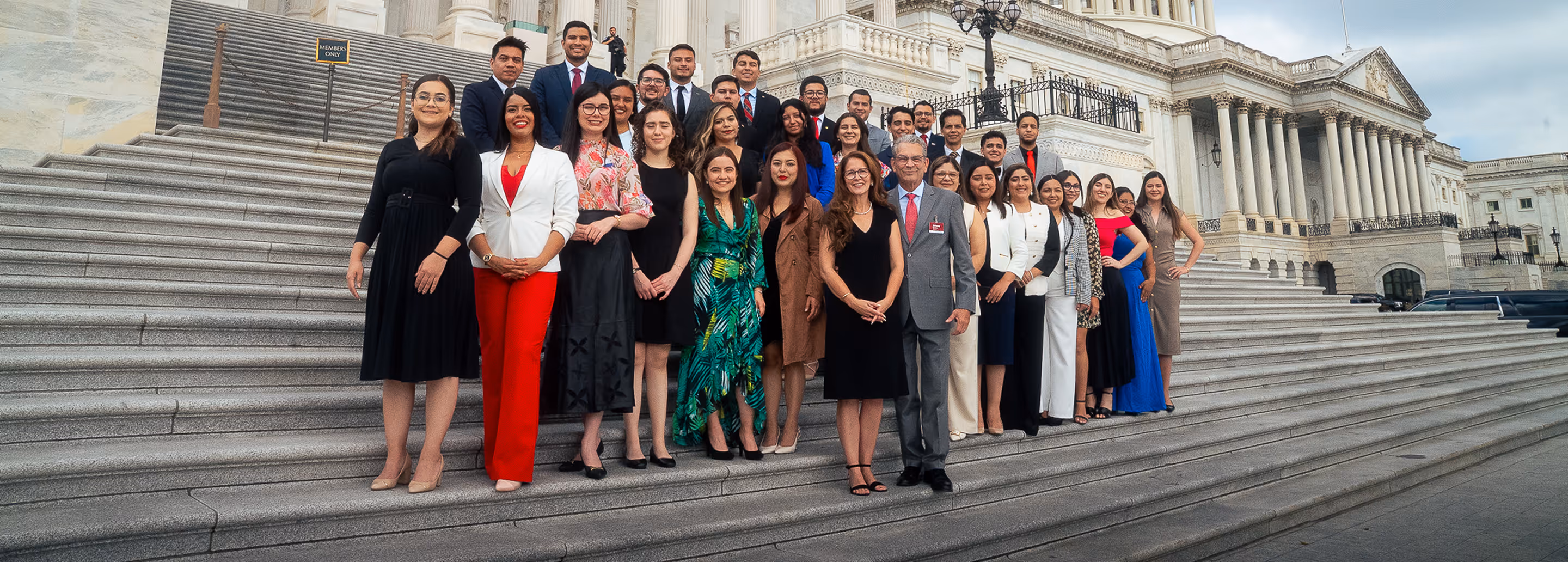A group of people standing on steps in front of a building.