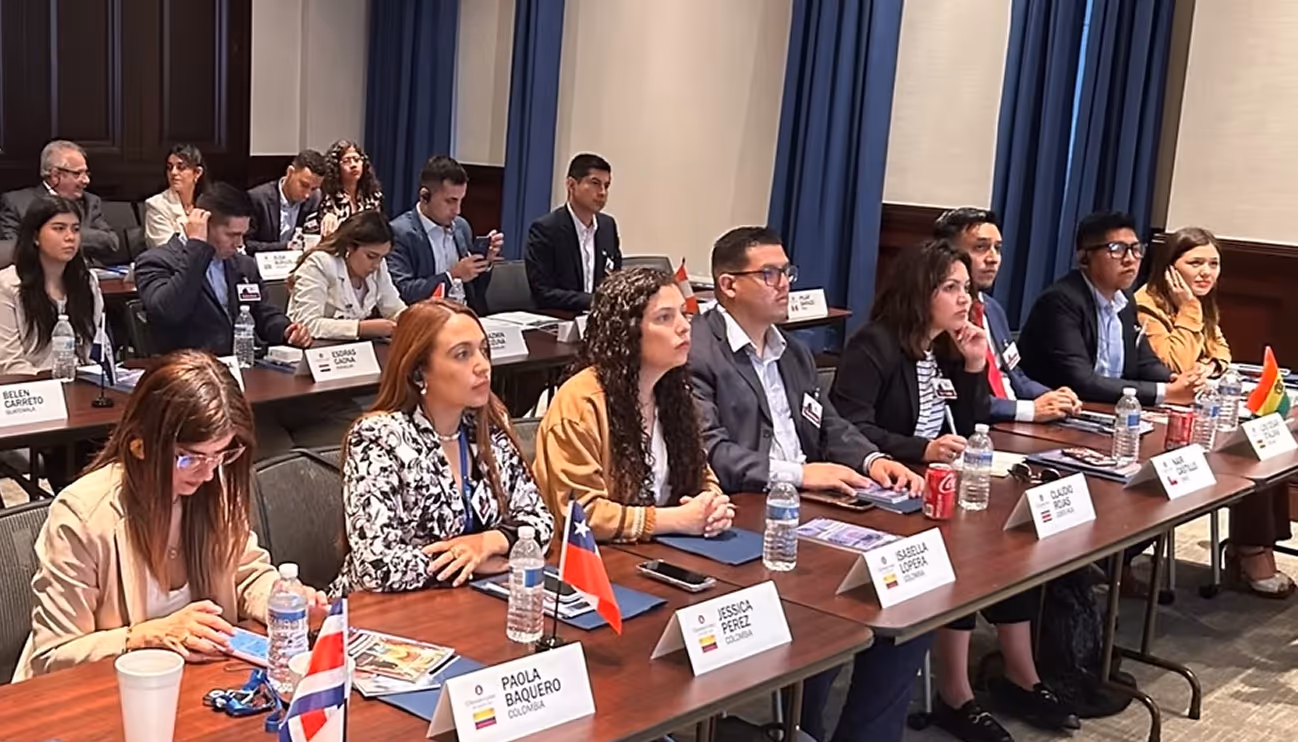 A group of people sitting at a long table.