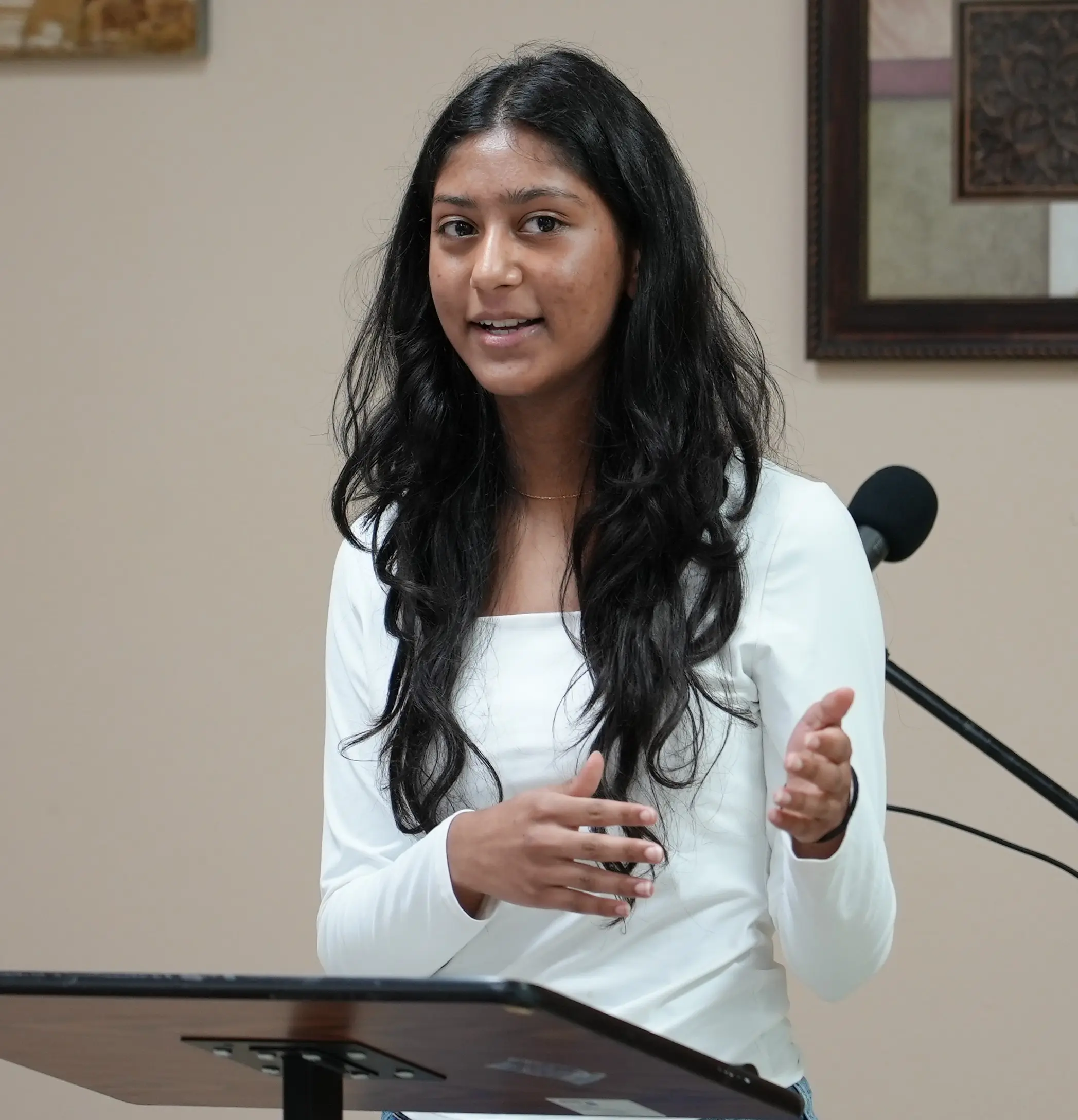 A teen member confidently addressing the room during a Toastmasters meeting