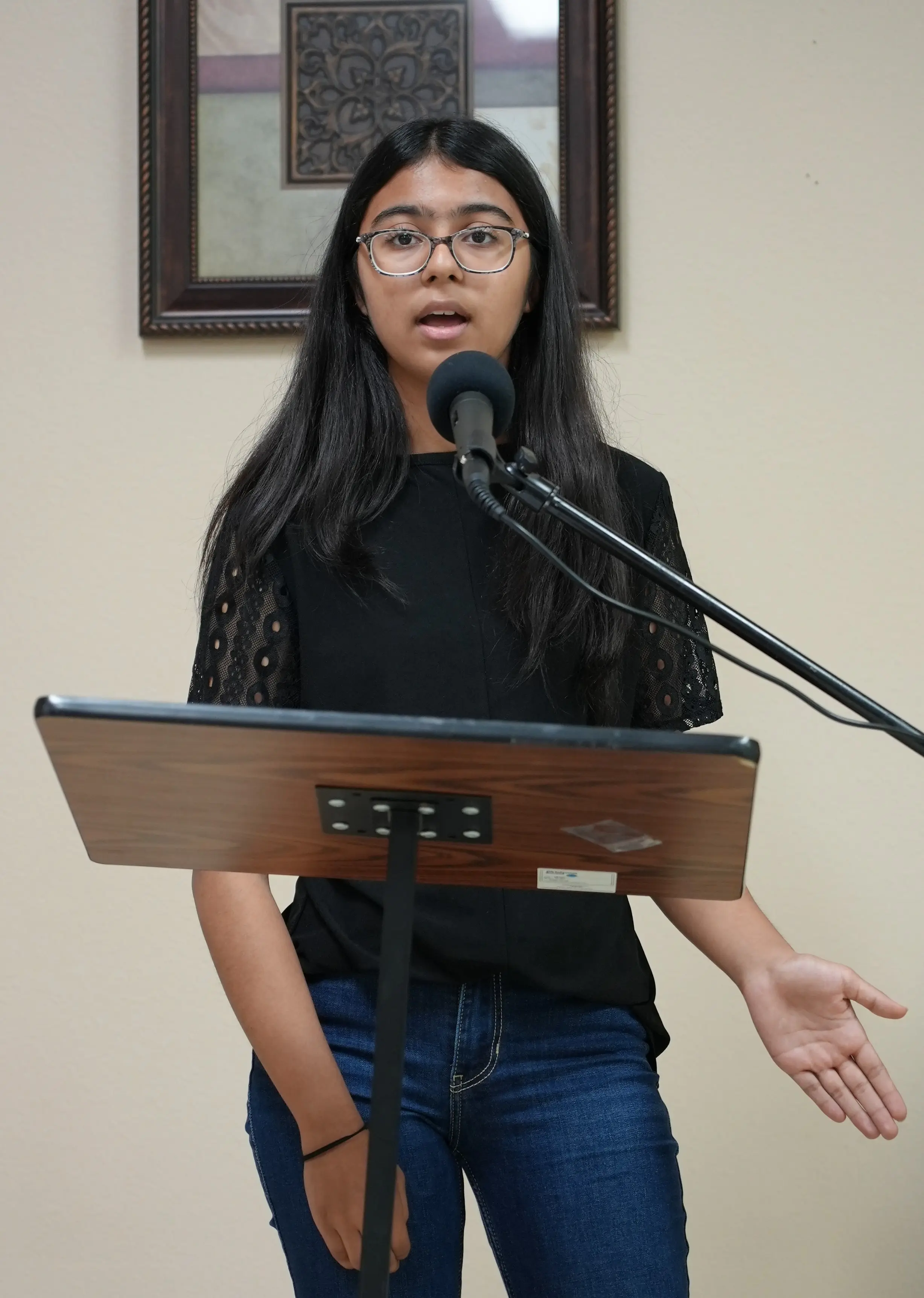 A JKYog Youth Club member delivering a prepared speech with confidence