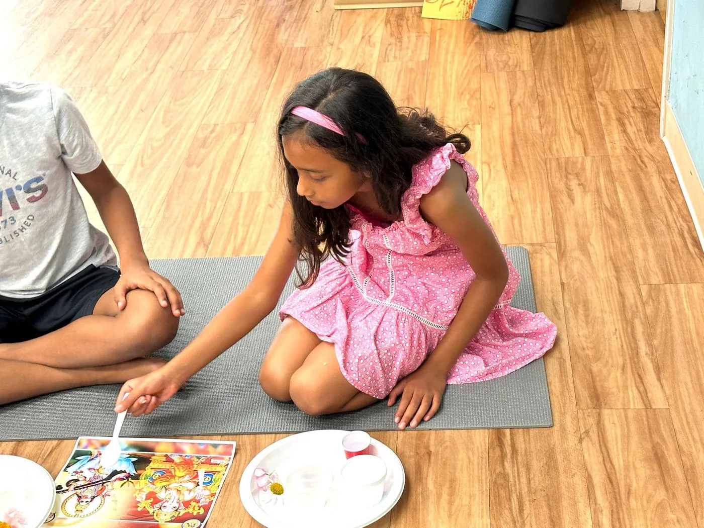 A child painting during a Diwali craft activity at the temple