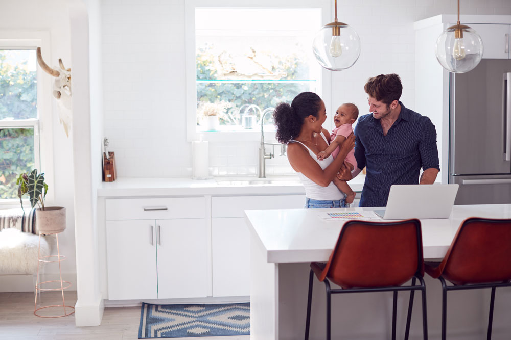 Family with a baby in a bright modern kitchen