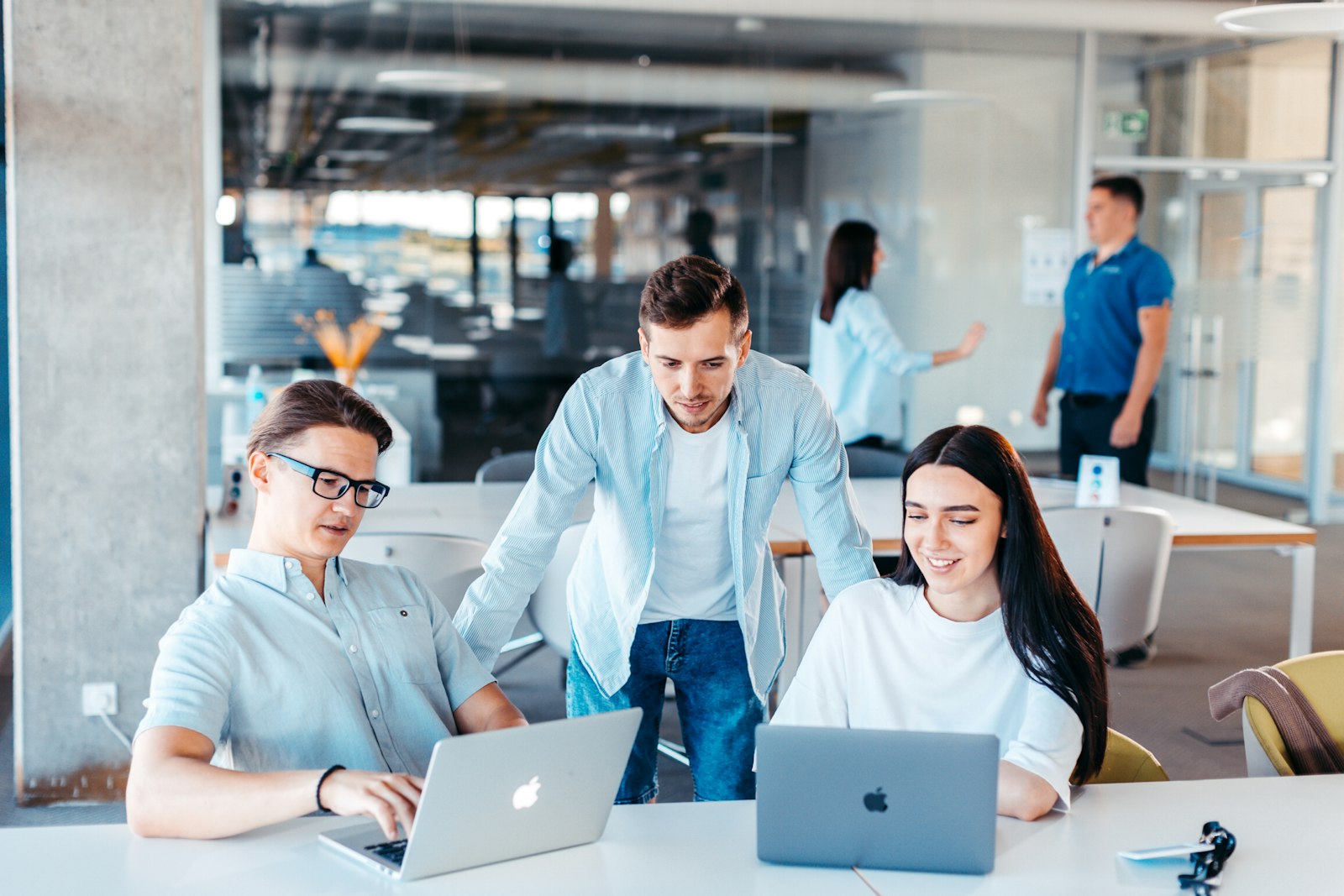A product team working together on laptops