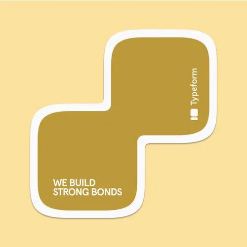 Typeform branded sticker in gold with We Build Strong Bonds text on yellow background
