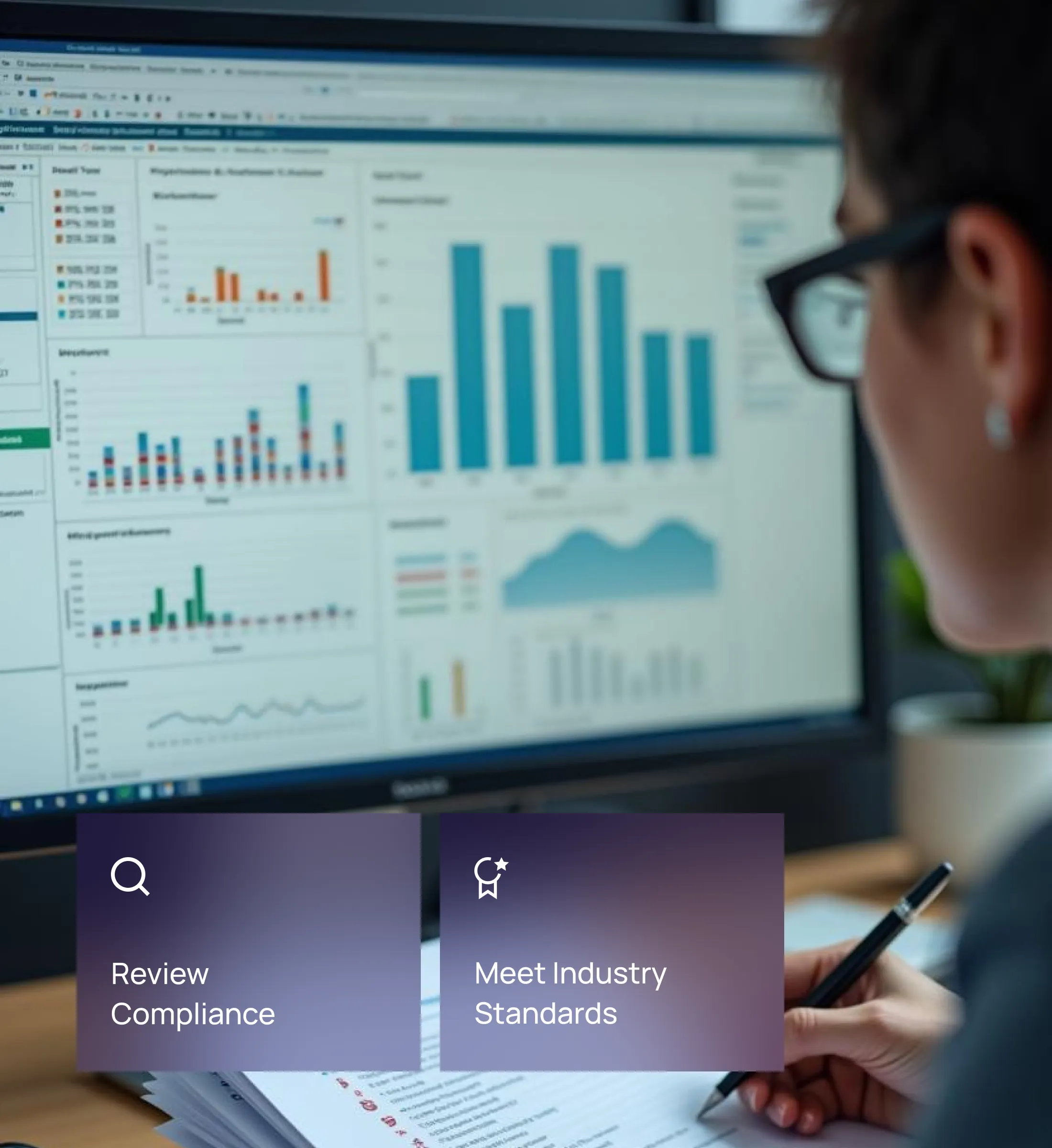 A professional reviewing compliance data on a computer screen displaying various charts and graphs, reflecting Fraxtional's review of compliance and meeting industry standards.