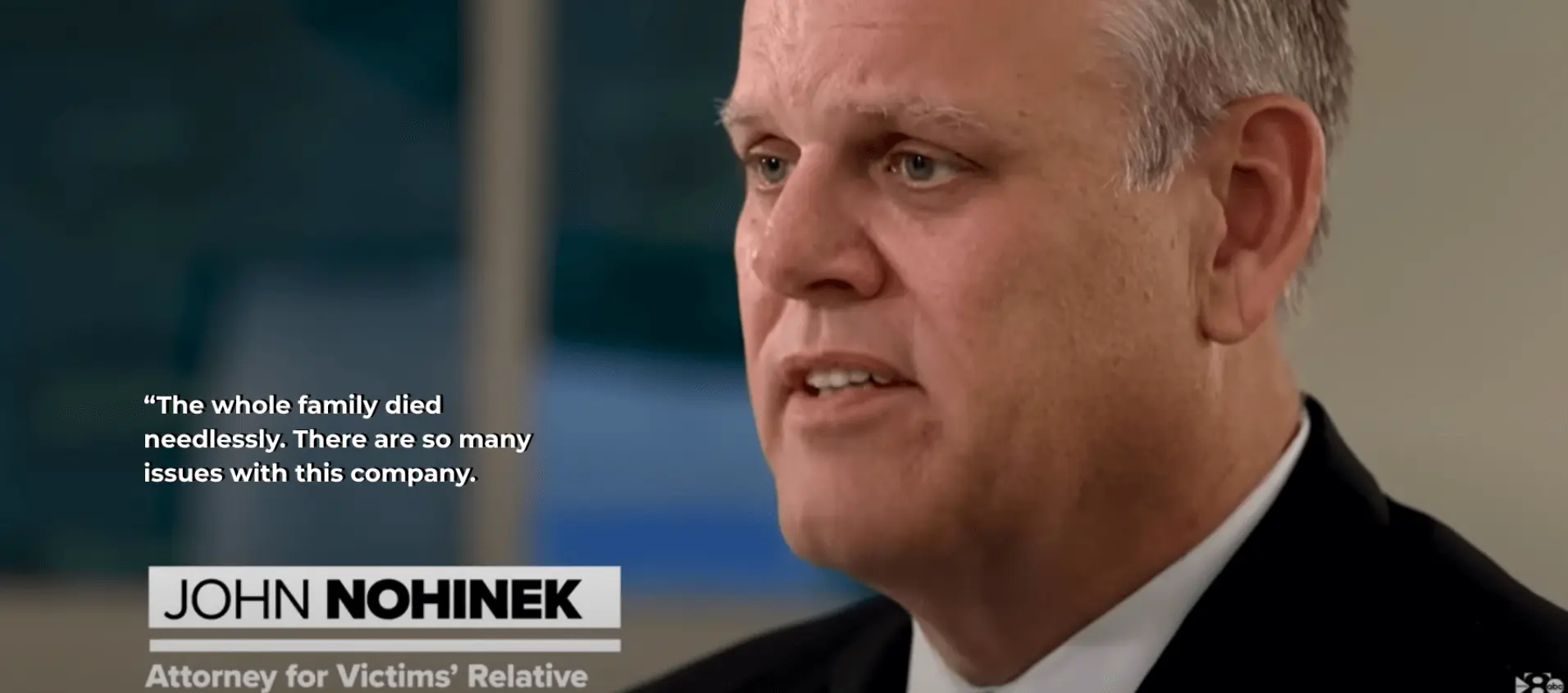 Video still of Attorney John Nohinek during an interview, with a quote overlay reading: "The whole family died needlessly. There are so many issues with this company." A title bar identifies him as "JOHN NOHINEK Attorney for Victims' Relative."