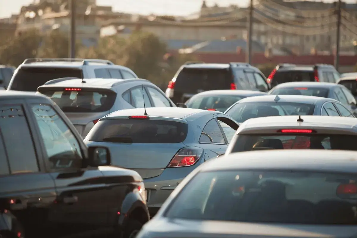 Close-up view of heavy traffic congestion during rush hour in a city, showing many cars packed bumper-to-bumper.