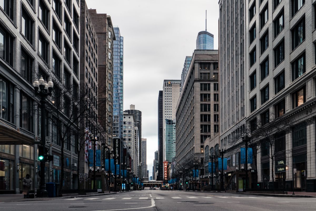 Downtown Chicago street lined with buildings, where delivery trucks share the road with cyclists and pedestrians