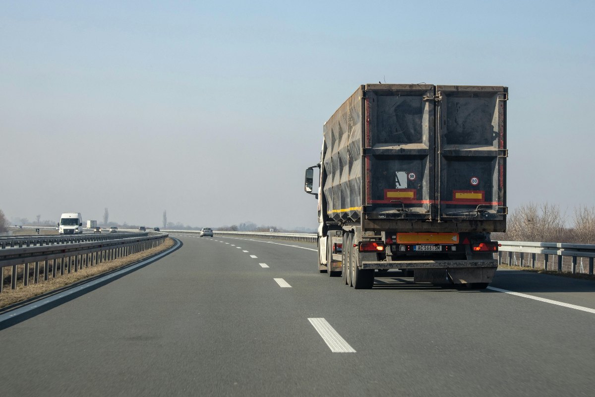 Semi-truck driving on a divided highway, illustrating how to prove negligence in a truck wreck claim