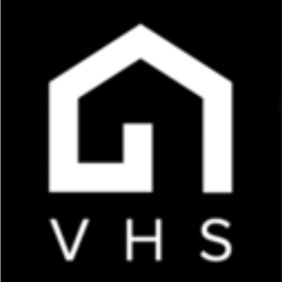 Original logo for the VHS app: a black square with a very angular, negative-space house shape and the letters "VHS," using a completely different style.