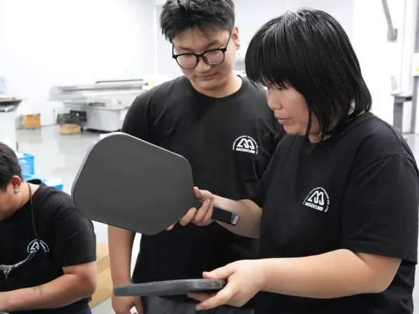 Mozkuib team checking base pickleball paddle face
