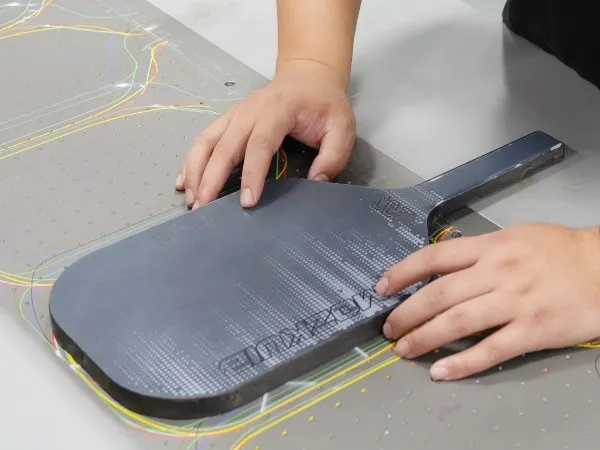 finished pickleball paddle face with applied surface texture