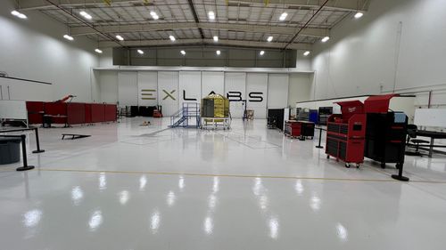 A grey architecture modern building with contemporary design style in a white sky blue sunrise background.