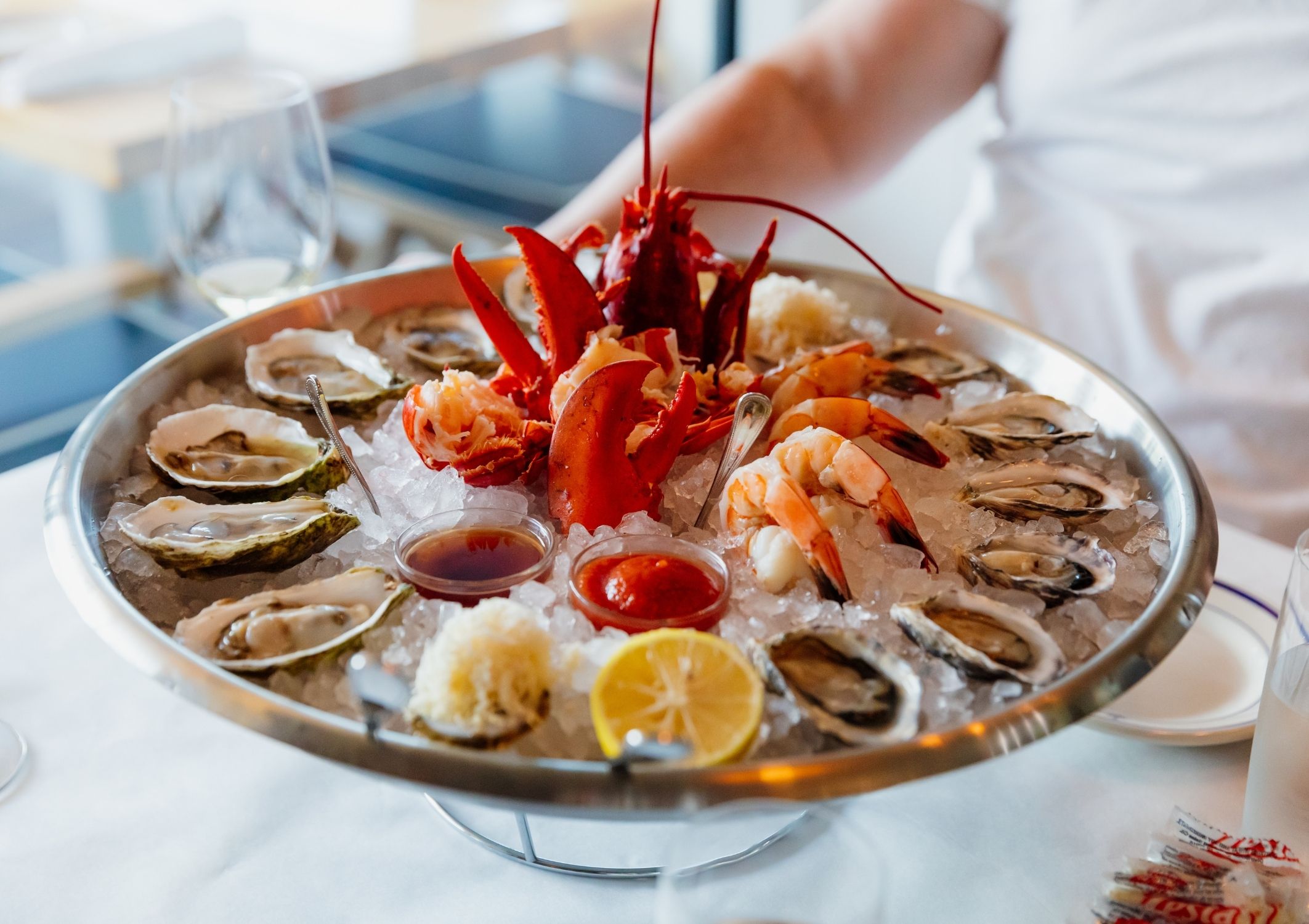 A tray of a dozen oysters and lobster tail at Clark's Oyster bar