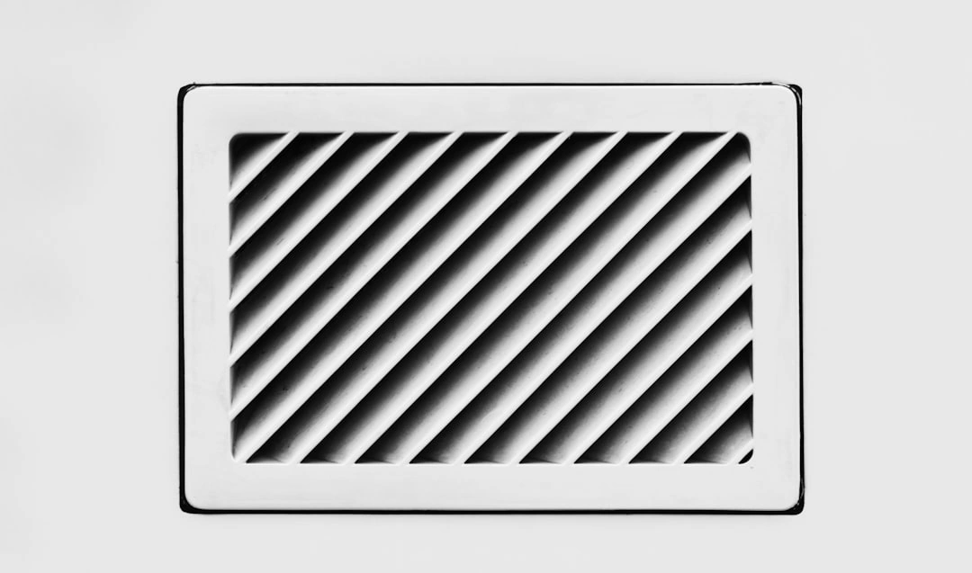 Close-up of a vent grille covered in thick grey dust and lint - signs your ductwork needs professional cleaning Close-up of a vent grille covered in thick grey dust and lint - signs your ductwork needs professional cleaning