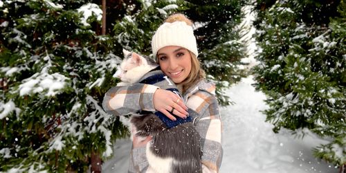 Ashley in snow with her cat Mickey.