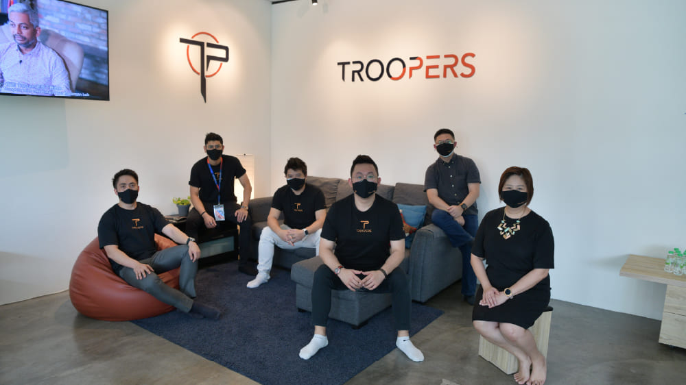 TROOPERS team celebrating Chinese New Year with vibrant lion dance and festive activities, fostering cultural diversity and unity in the workplace.