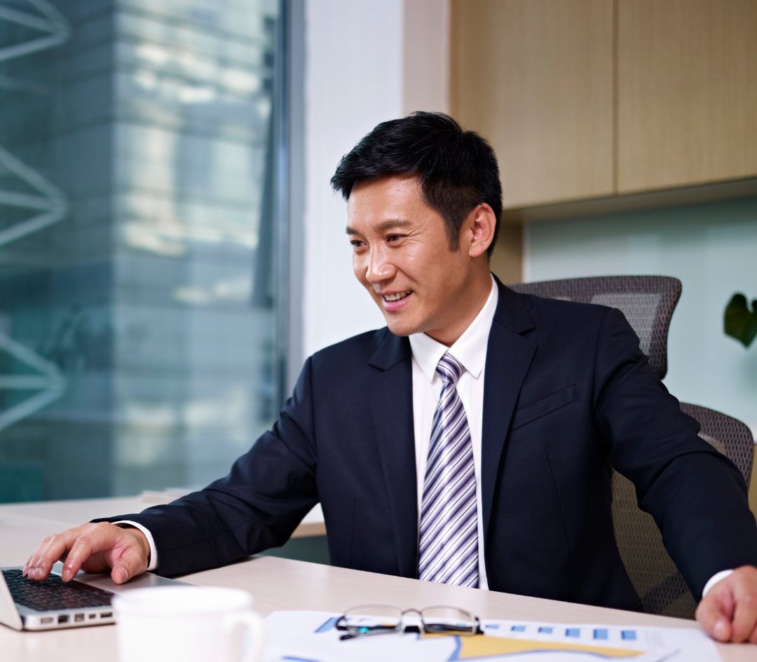 Confident woman in white shirt holding laptop.