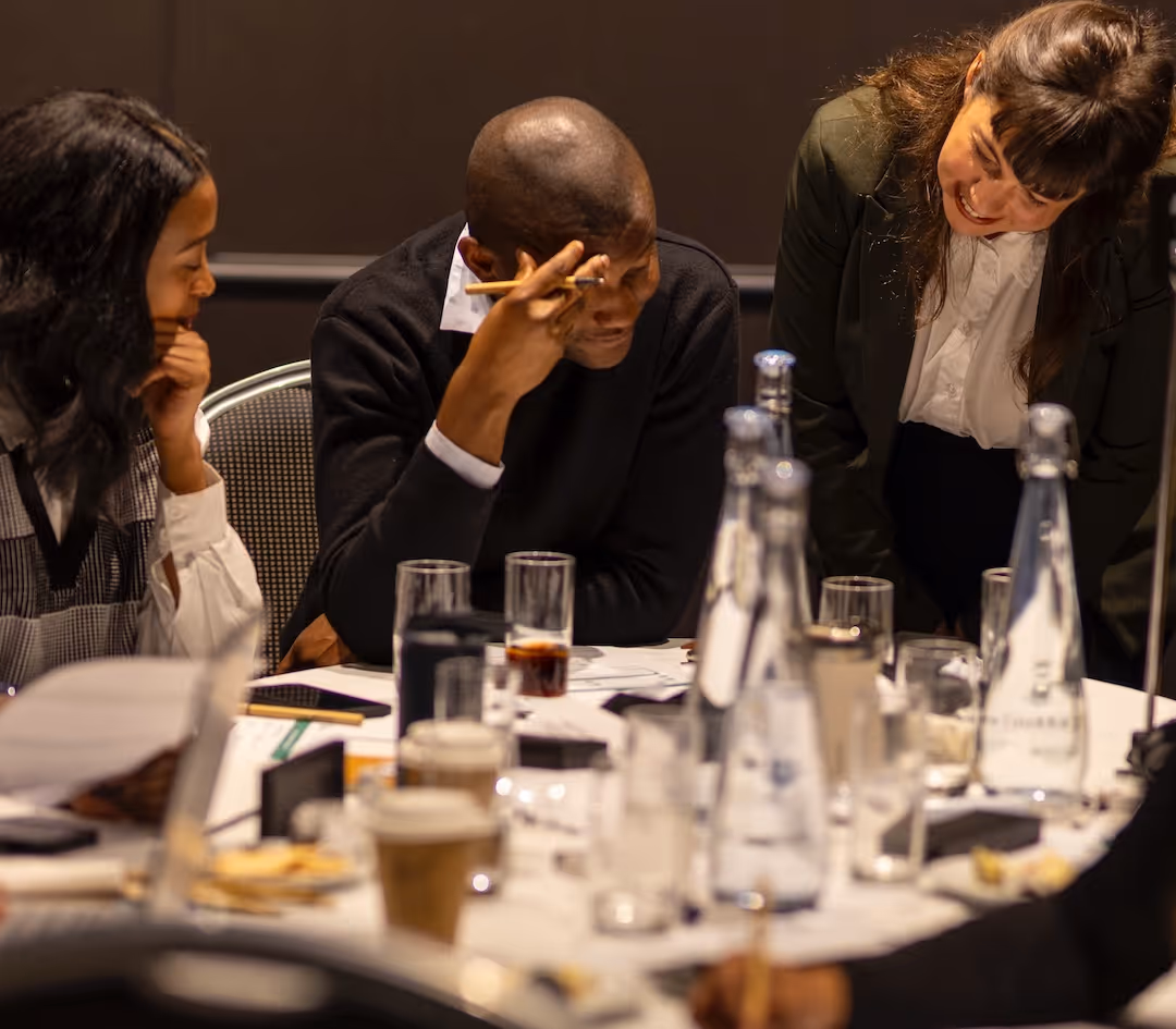 Confident woman in white shirt holding laptop.