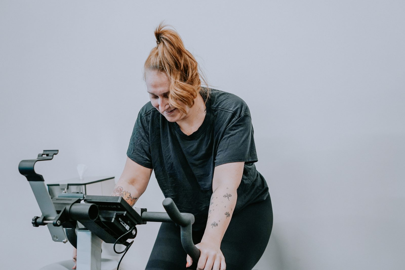 A member rides an exercise bike in the proof3 studio.