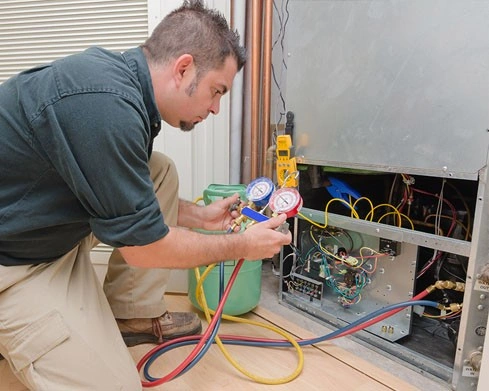 Man testing heater with gauges.