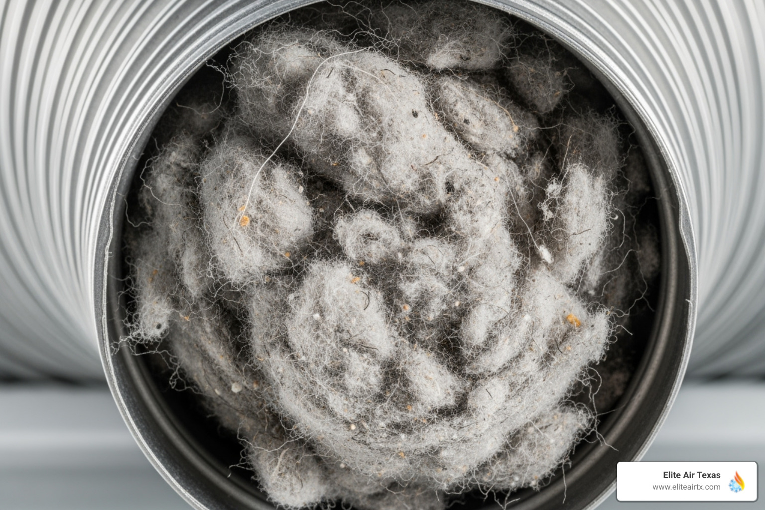 A dryer vent pipe clogged with a dense accumulation of lint - dryer vent cleaning near me