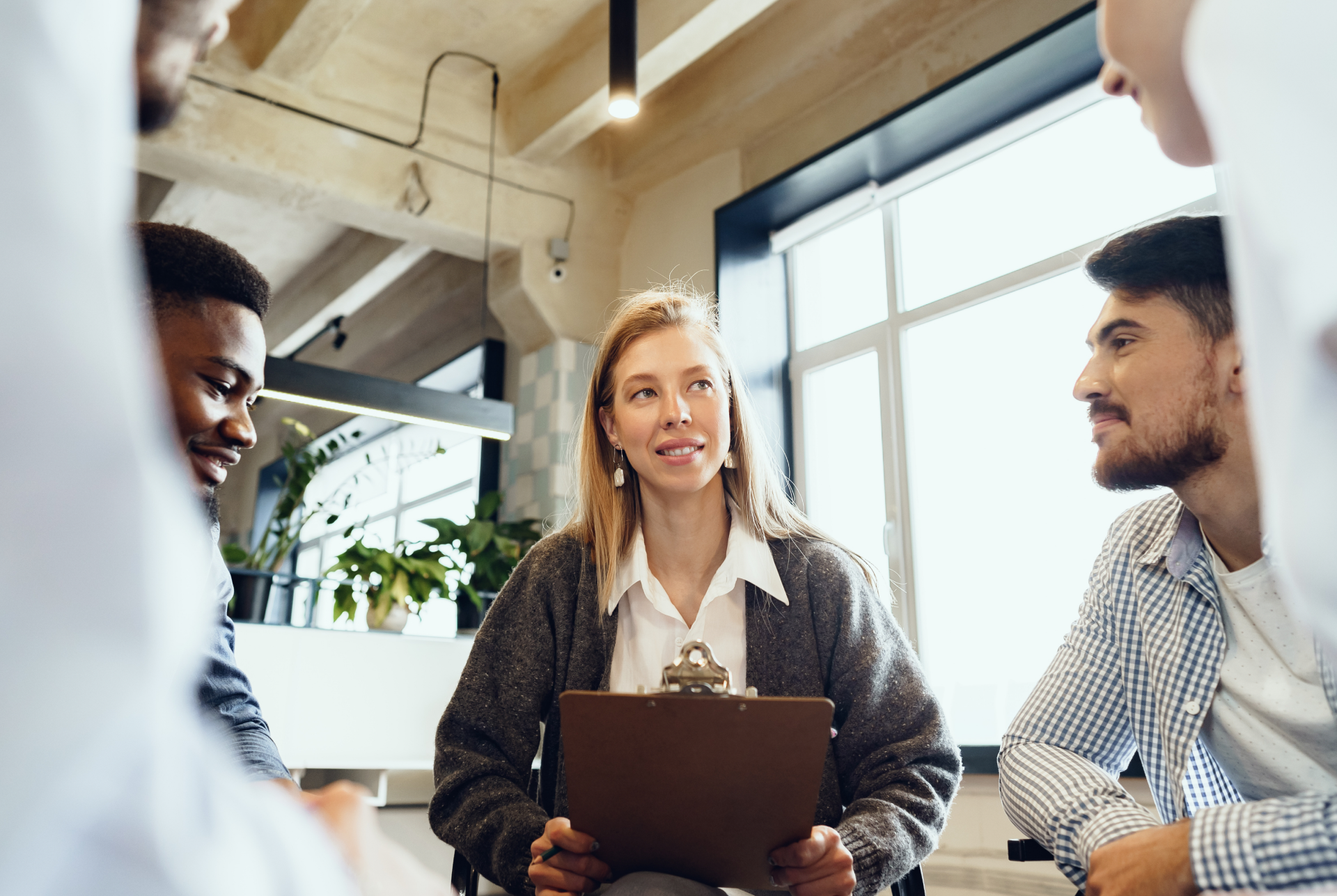 Marketing team discussing AI marketing agents around a laptop in a meeting