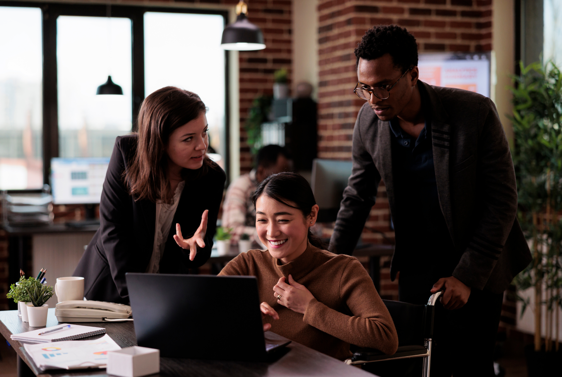 Content team reviewing AI-assisted work together at a laptop