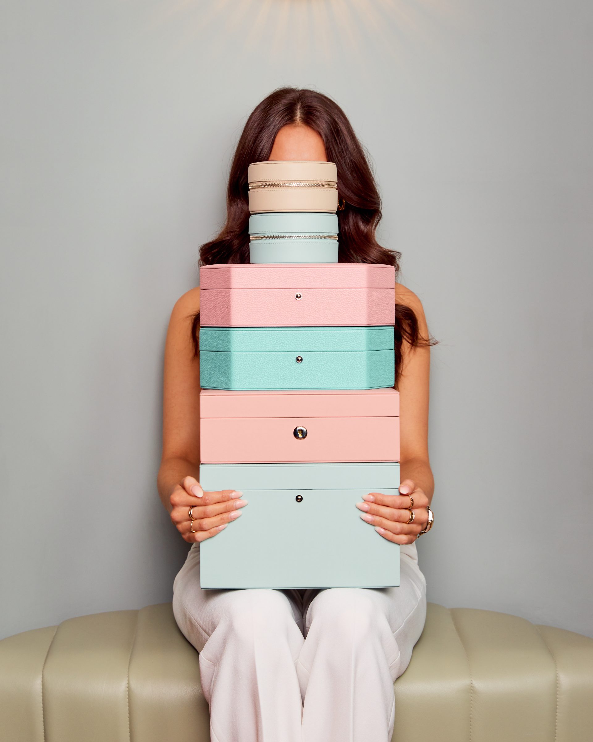 Woman holding a stack of Rapport London gift boxes, shot by 303 London