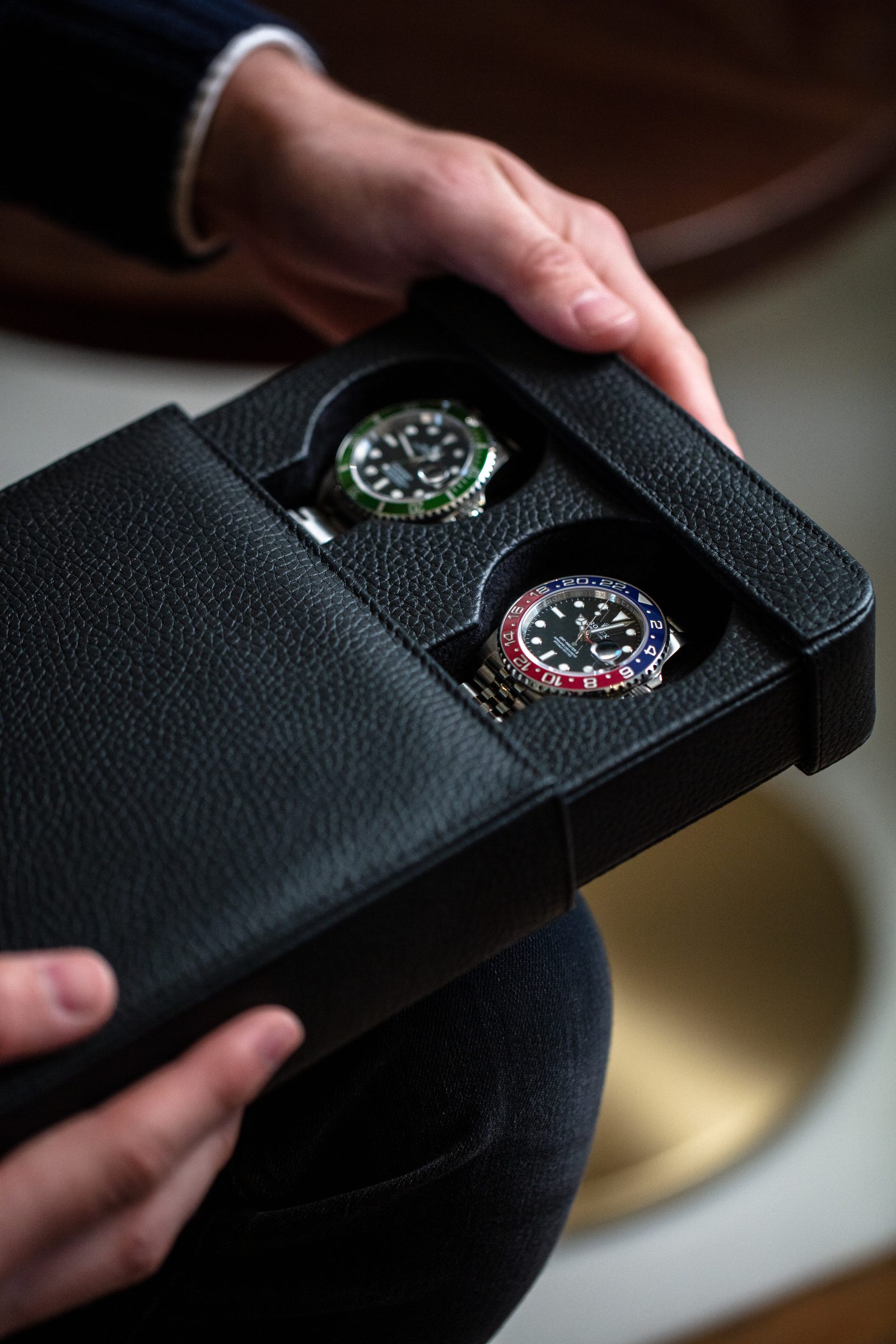 Hands holding a Rapport London leather watch case, shot by 303 London