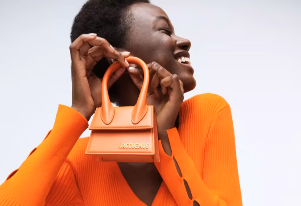 Jacquemus mini handbag in a vibrant shade of orange, showcasing the brand's distinct minimalist design and compact size.