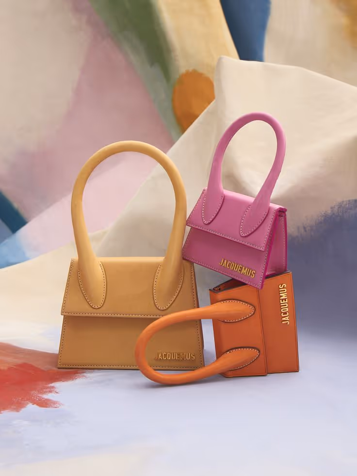Array of Jacquemus handbags in varying colors and sizes, showcasing the brand's unique design aesthetics.