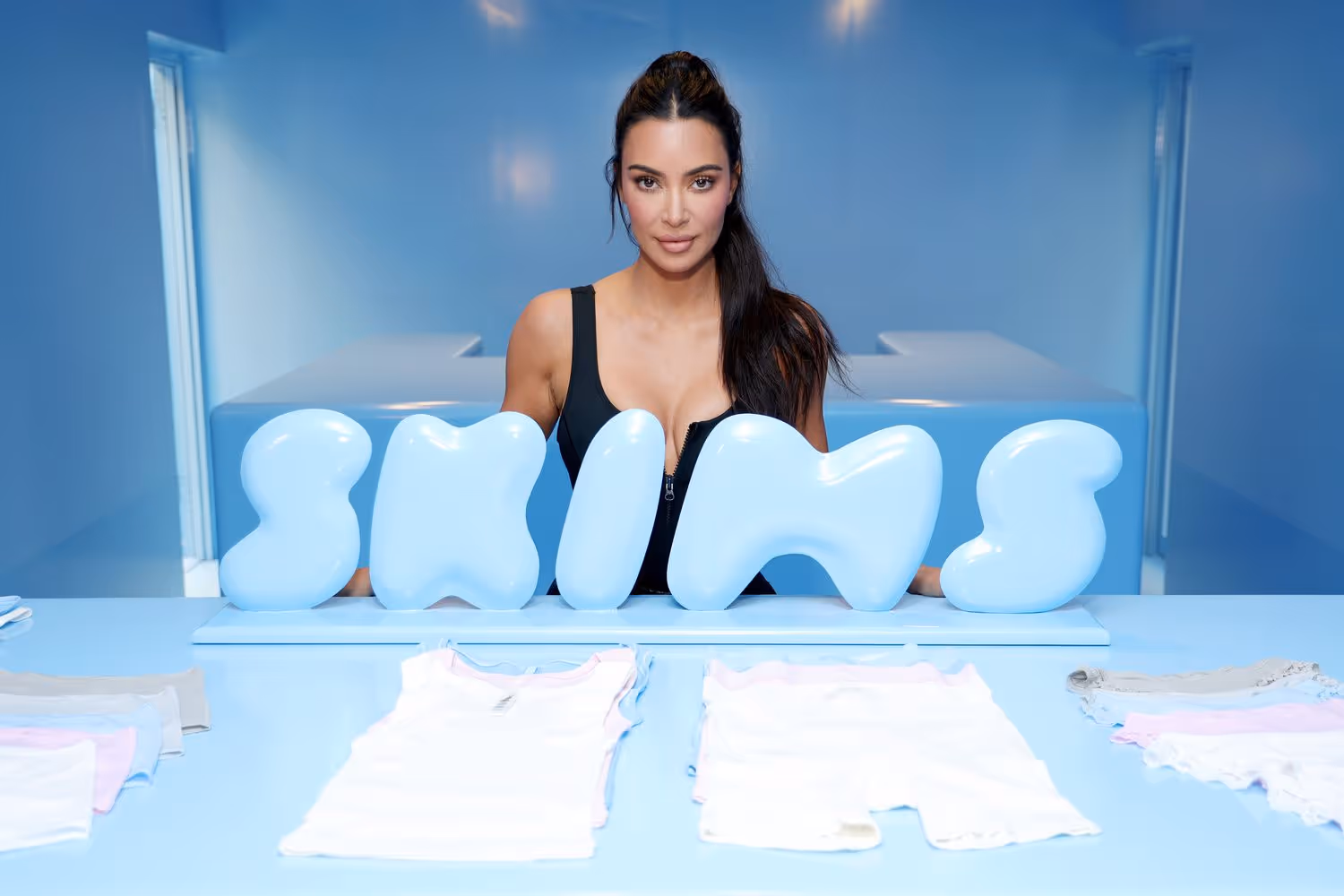 Kim Kardashian poses confidently in SKIMS apparel, showcasing the brand's modern shapewear designs and her signature style.