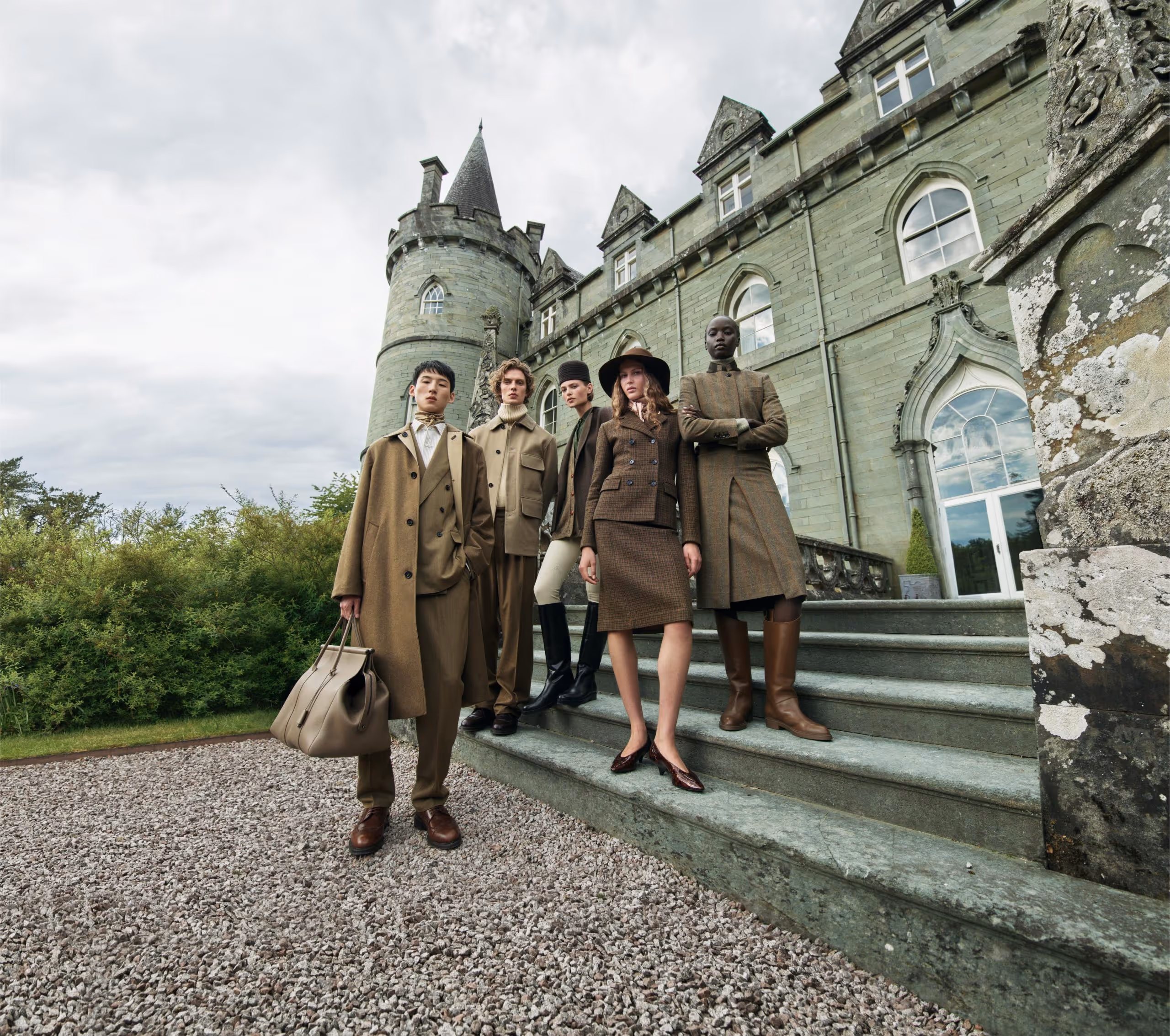 Models embodying the essence of quiet luxury in Loro Piana's centennial campaign, set against the breathtaking landscapes of Scotland, showcasing the brand's rich heritage and commitment to timeless craftsmanship