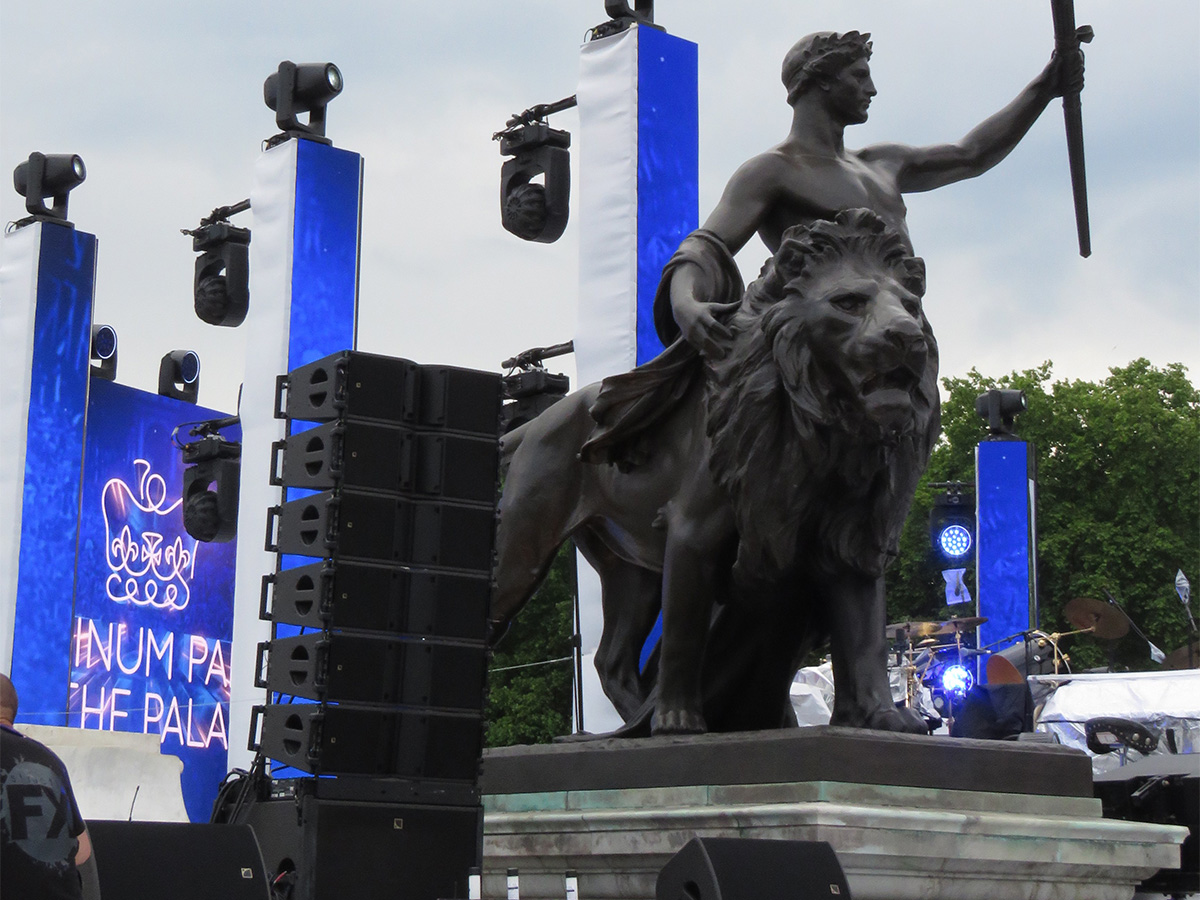 Lion statue at Buckingham Palace next to L-Acoustics speakers